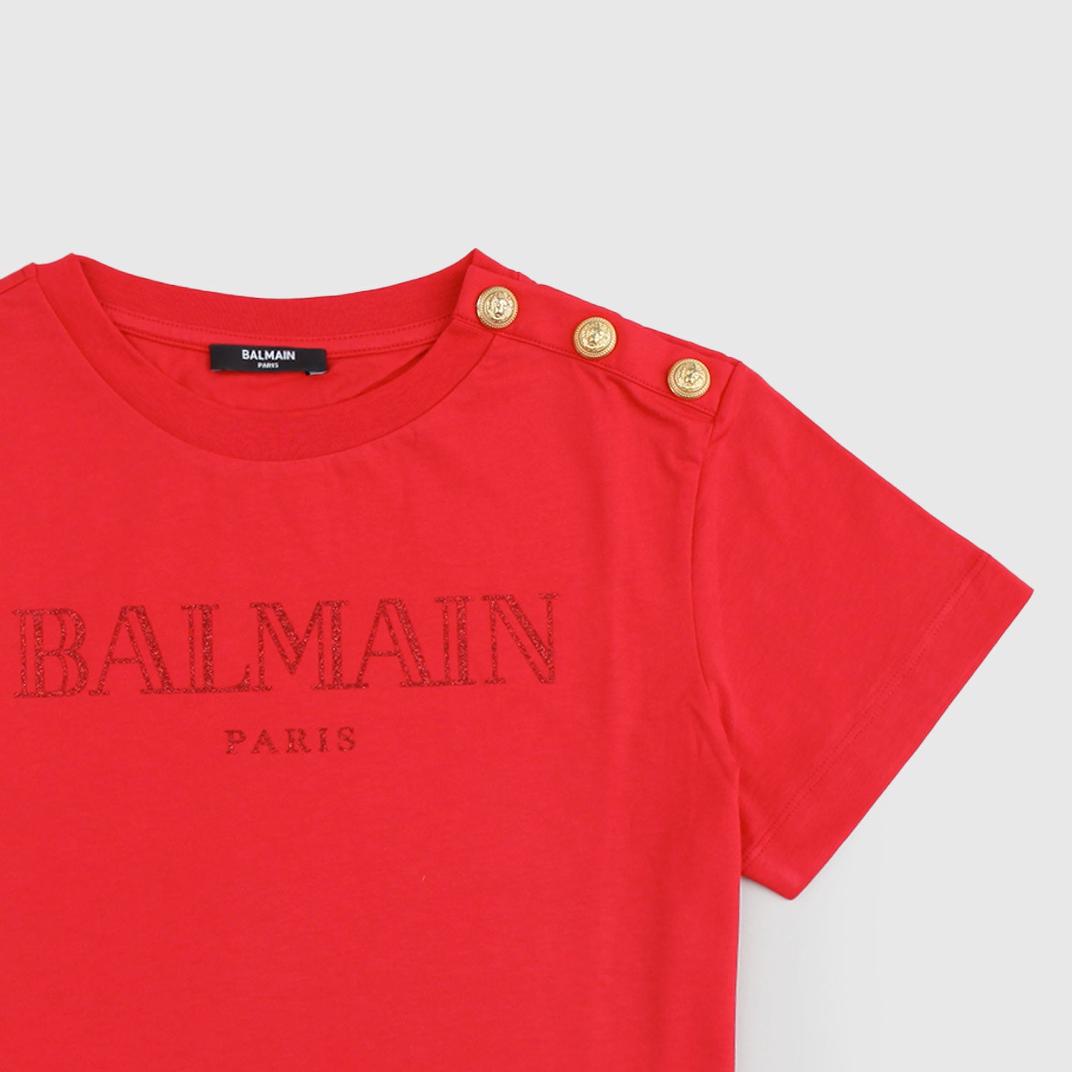 T-shirt rossa con logo glitterato e bottoni - annameglio.com abbigliamento moda