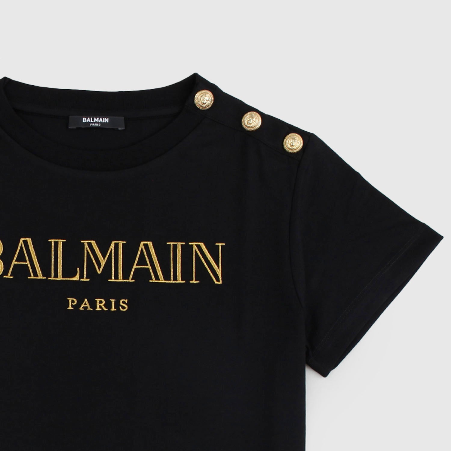 T-shirt nera con logo e bottoncini d’oro - annameglio.com abbigliamento moda
