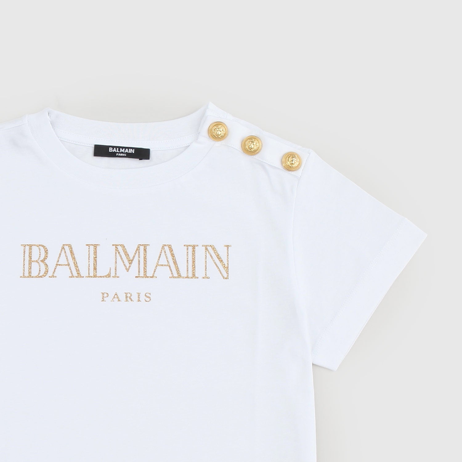 T-shirt con logo d’oro e bottoni dorati - annameglio.com abbigliamento moda