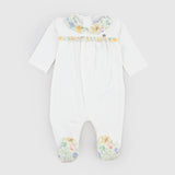 Milk-colored romper with patterned details by COCCODE