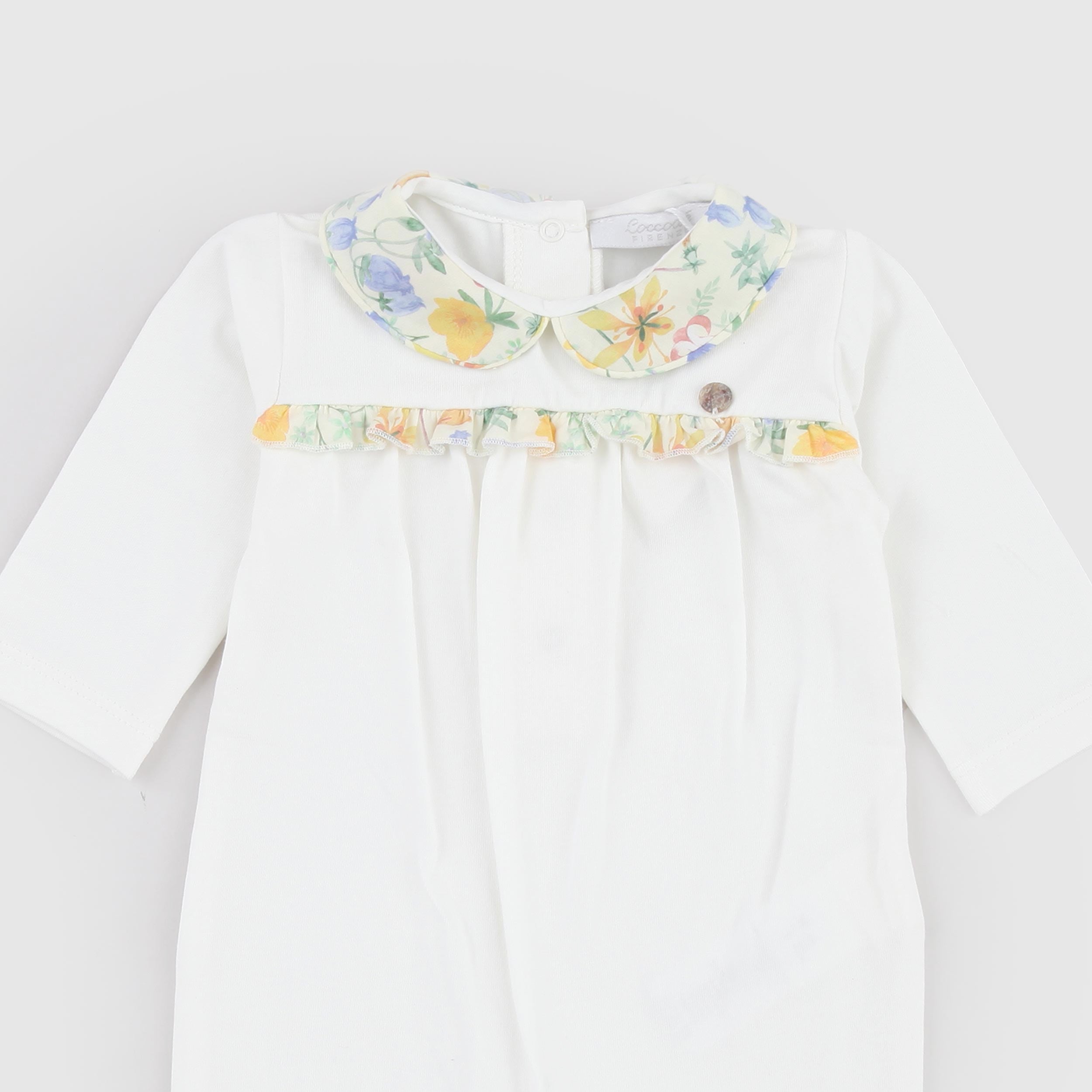 Milk-colored romper with patterned details by COCCODE