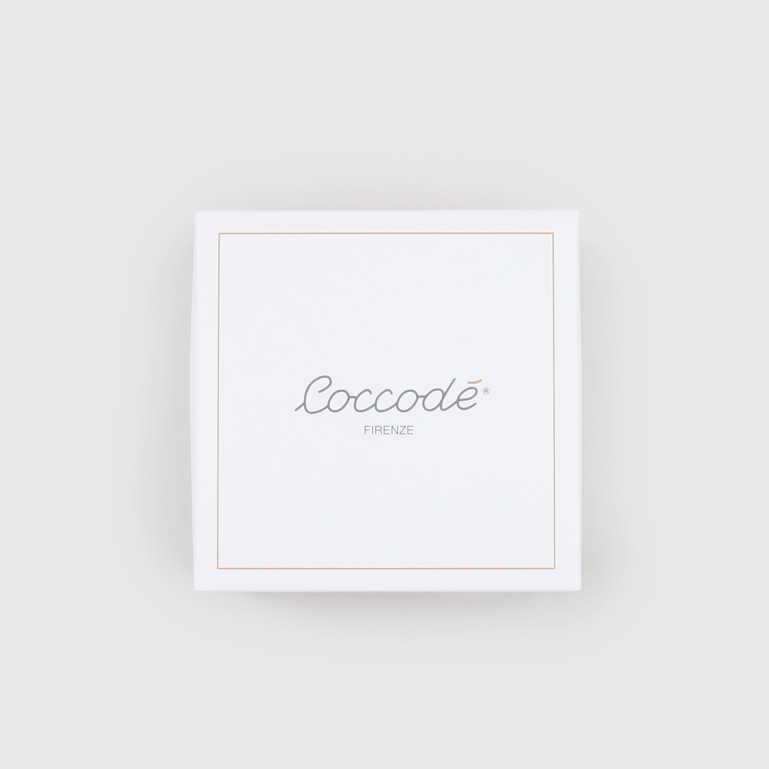 Milk-colored romper with patterned details by COCCODE